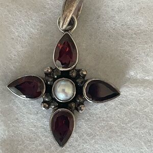 Garnet cross with simulated pearl in the center. Set in 925 sterling silver.